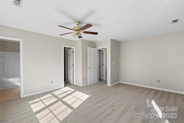 unfurnished bedroom featuring carpet flooring, baseboards, and visible vents