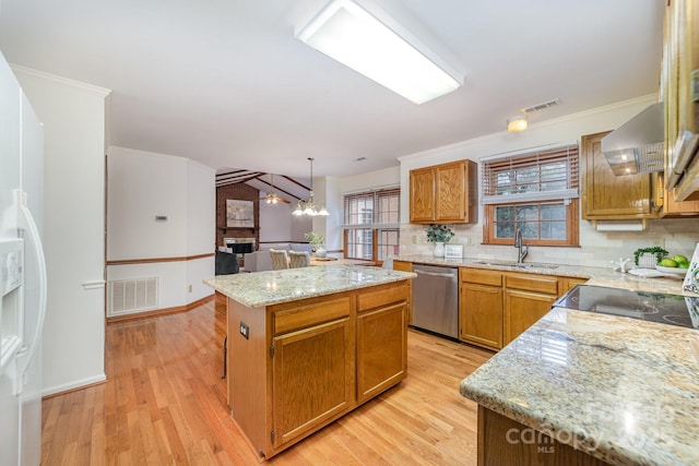 kitchen featuring light wood-style floors, visible vents, a sink, and stainless steel dishwasher