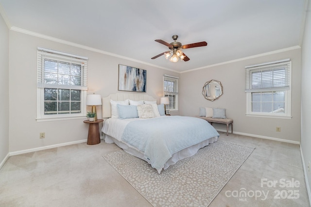 carpeted bedroom featuring ornamental molding, multiple windows, and baseboards