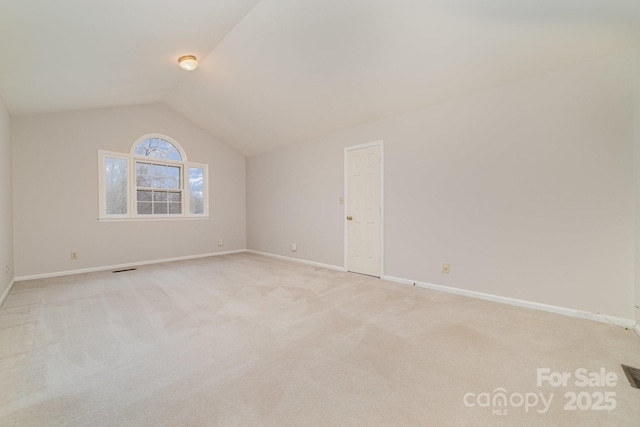 bonus room featuring light carpet, baseboards, and vaulted ceiling