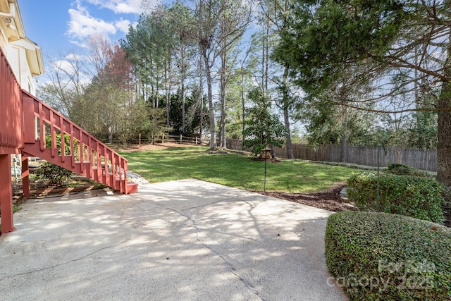 view of patio with a fenced backyard and stairway