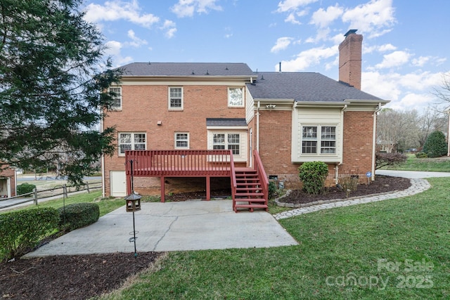 back of house with crawl space, a patio area, a lawn, and a chimney