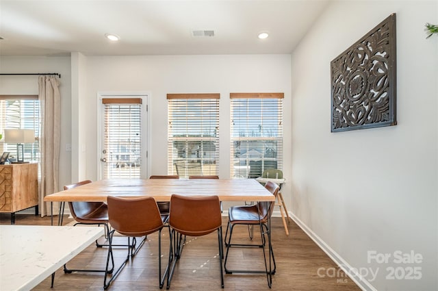 dining room with baseboards, visible vents, wood finished floors, and recessed lighting