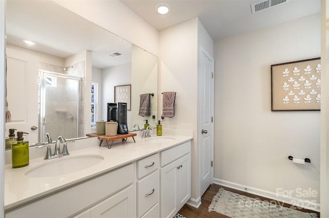 full bathroom with a shower stall, visible vents, and a sink