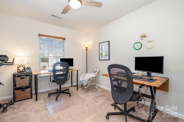 carpeted office featuring baseboards, visible vents, and ceiling fan