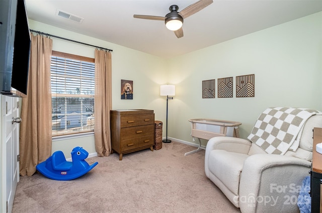 sitting room with carpet, visible vents, ceiling fan, and baseboards