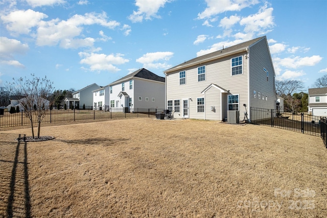 rear view of property with a residential view, a fenced backyard, a yard, and cooling unit