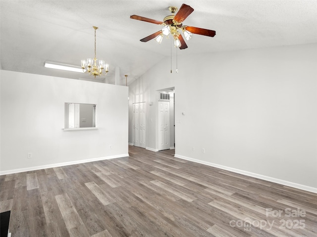 unfurnished room featuring lofted ceiling, visible vents, baseboards, and wood finished floors