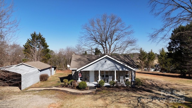 view of front facade with covered porch and an outdoor structure