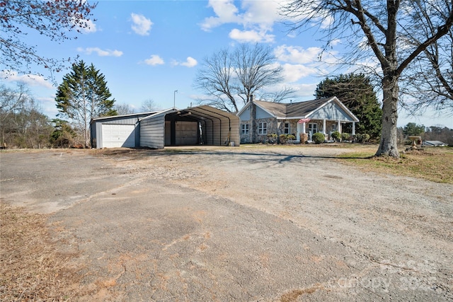 view of front facade with driveway and a detached carport