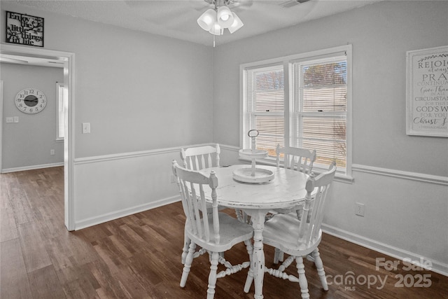 dining space with ceiling fan, visible vents, baseboards, and wood finished floors