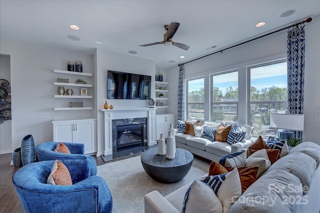 living area with a fireplace, visible vents, and recessed lighting