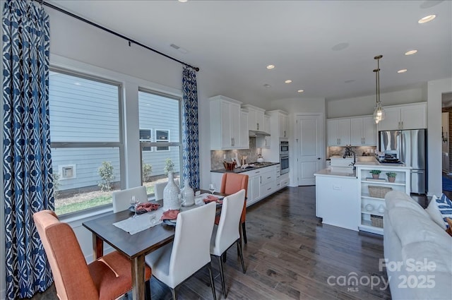 dining space featuring recessed lighting, dark wood-style floors, and a wealth of natural light