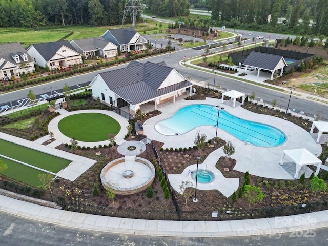 community pool featuring a patio area and fence