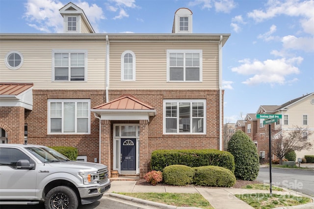 townhome / multi-family property featuring brick siding