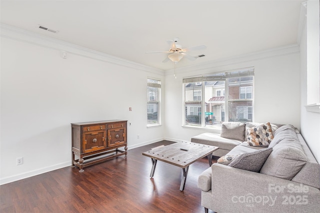 living area featuring visible vents, ornamental molding, wood finished floors, baseboards, and ceiling fan