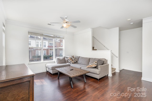 living room featuring visible vents, ceiling fan, stairway, ornamental molding, and wood finished floors