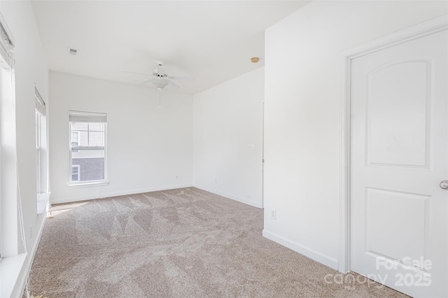 unfurnished room with visible vents, baseboards, ceiling fan, and carpet flooring