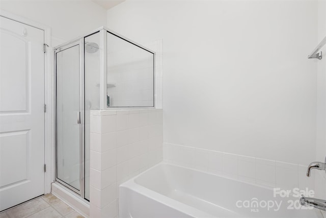 full bath with a bath, a shower stall, and tile patterned flooring