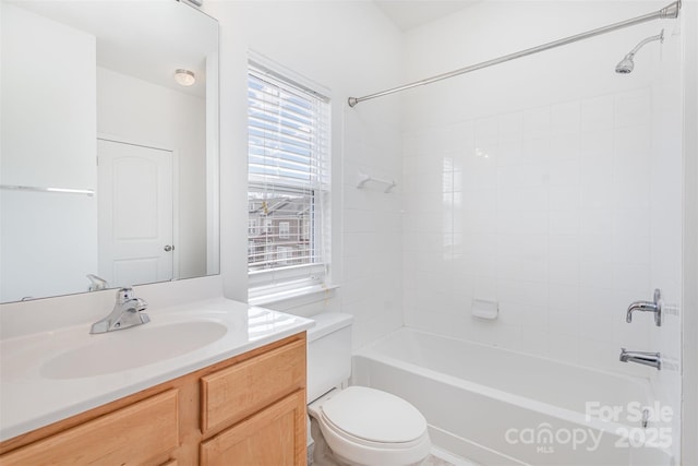 bathroom featuring shower / washtub combination, toilet, and vanity