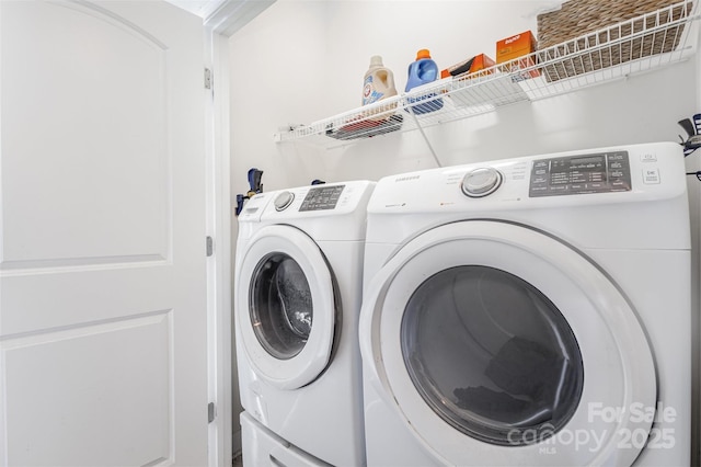 clothes washing area featuring laundry area and separate washer and dryer