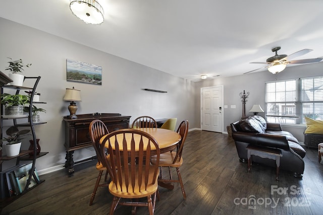 dining area with dark wood finished floors, baseboards, and ceiling fan