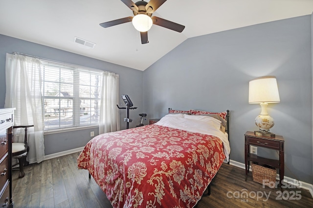 bedroom featuring lofted ceiling, wood finished floors, visible vents, and baseboards