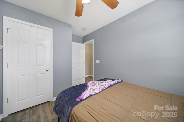 bedroom with baseboards, ceiling fan, and wood finished floors