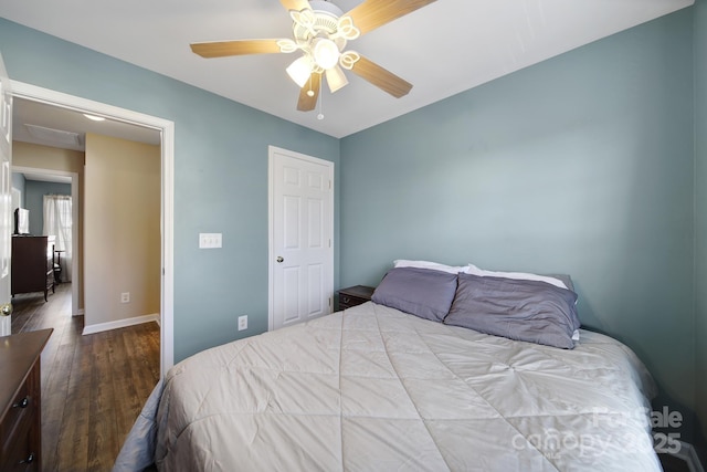 bedroom with a ceiling fan, wood finished floors, and baseboards