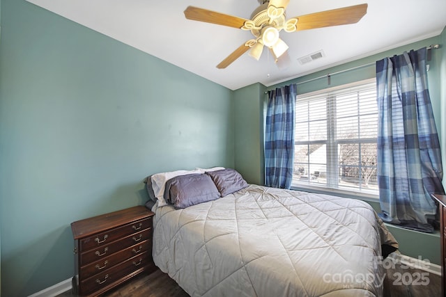 bedroom with visible vents, baseboards, ceiling fan, and wood finished floors