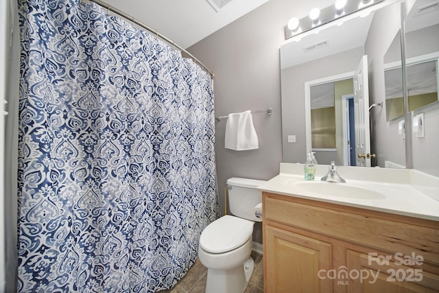 bathroom featuring tile patterned floors, visible vents, toilet, and vanity