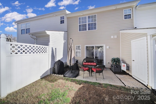 back of house featuring a patio area and fence