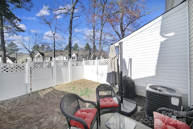 view of patio / terrace with central AC unit, a grill, and fence