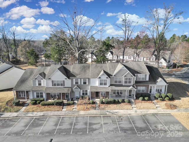 view of front of home featuring a residential view and uncovered parking