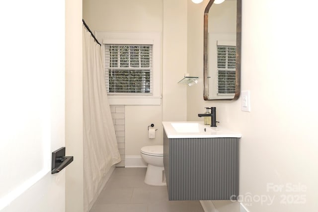 full bath featuring vanity, baseboards, tile patterned floors, and toilet