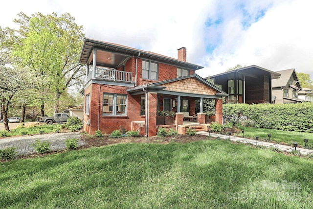 back of house featuring a porch, brick siding, a lawn, and a chimney