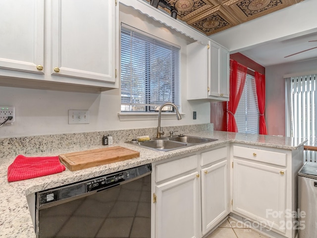 kitchen with white cabinetry, light countertops, black dishwasher, and a sink