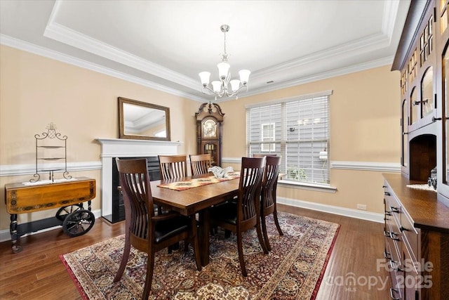 dining area featuring an inviting chandelier, a fireplace, and dark wood-type flooring