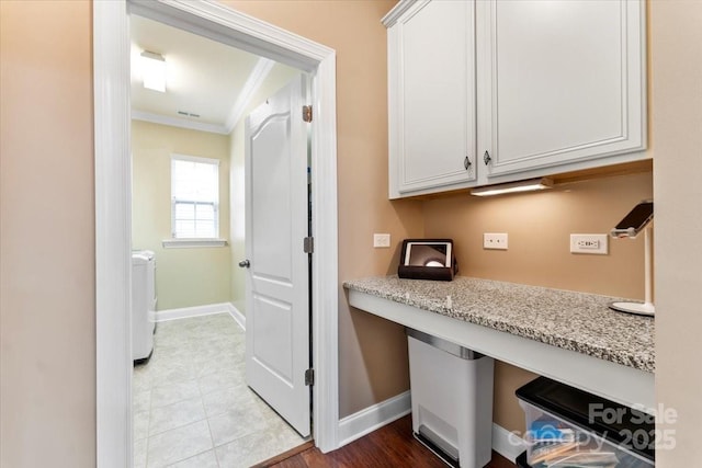 interior space featuring laundry area, ornamental molding, washer / clothes dryer, and baseboards