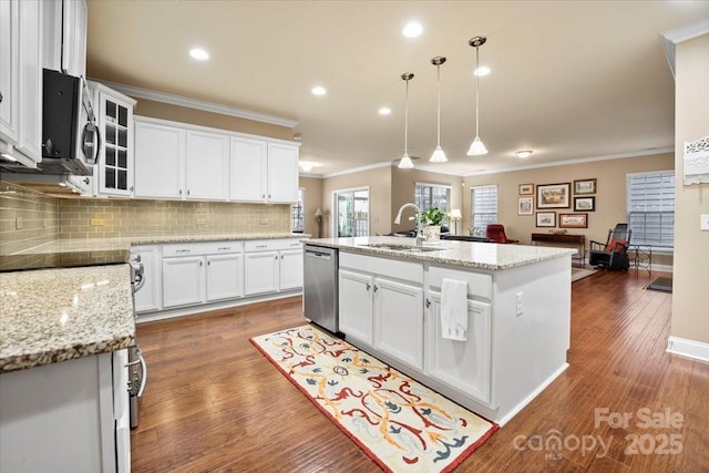 kitchen with appliances with stainless steel finishes, dark wood-style flooring, white cabinets, and a sink