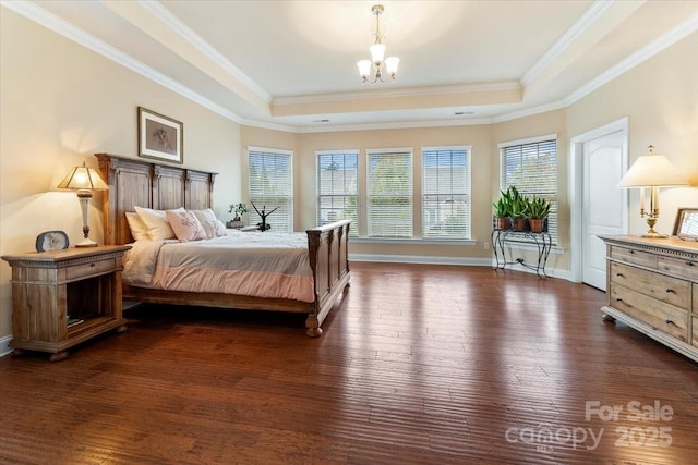 bedroom with dark wood-style floors and a tray ceiling