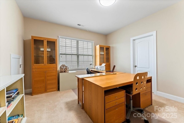 office space with visible vents, light carpet, and baseboards