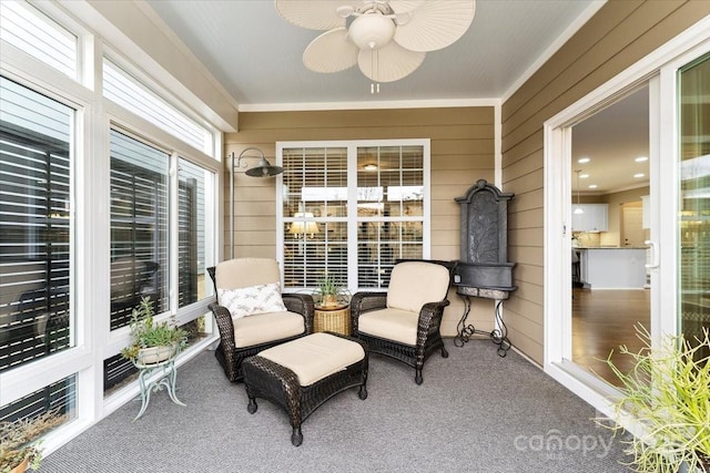 sunroom / solarium featuring ceiling fan