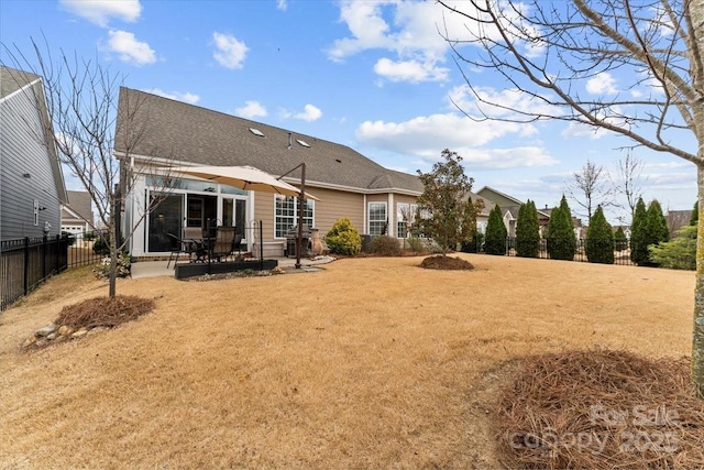 back of property featuring fence private yard, a patio area, and a yard