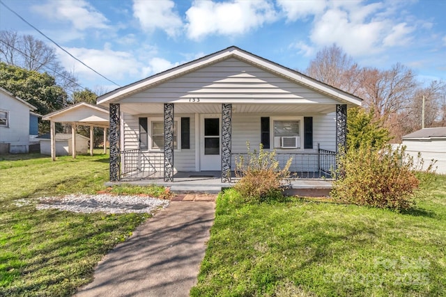 bungalow-style house featuring a porch and a front yard