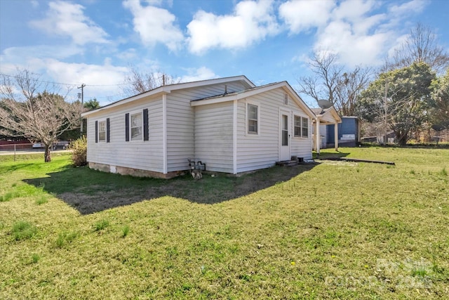 view of side of property with a lawn