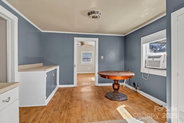 dining area with baseboards, crown molding, light wood finished floors, and ceiling fan