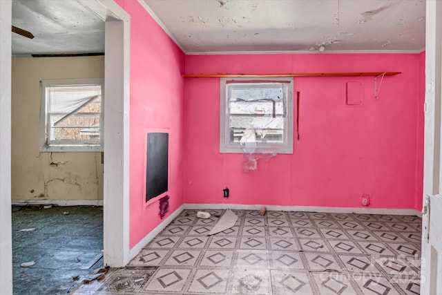 clothes washing area featuring light floors and baseboards