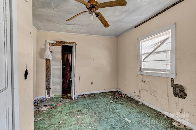 empty room featuring a ceiling fan and tile patterned floors