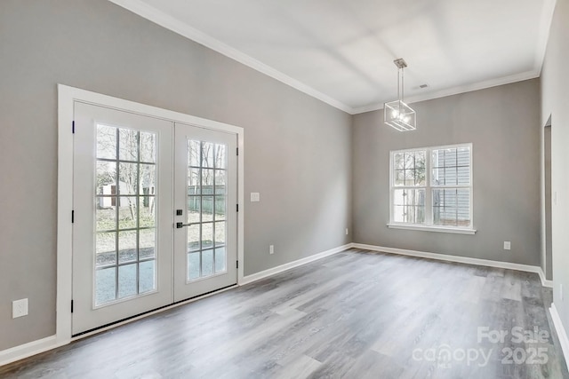 entryway with ornamental molding, french doors, baseboards, and wood finished floors